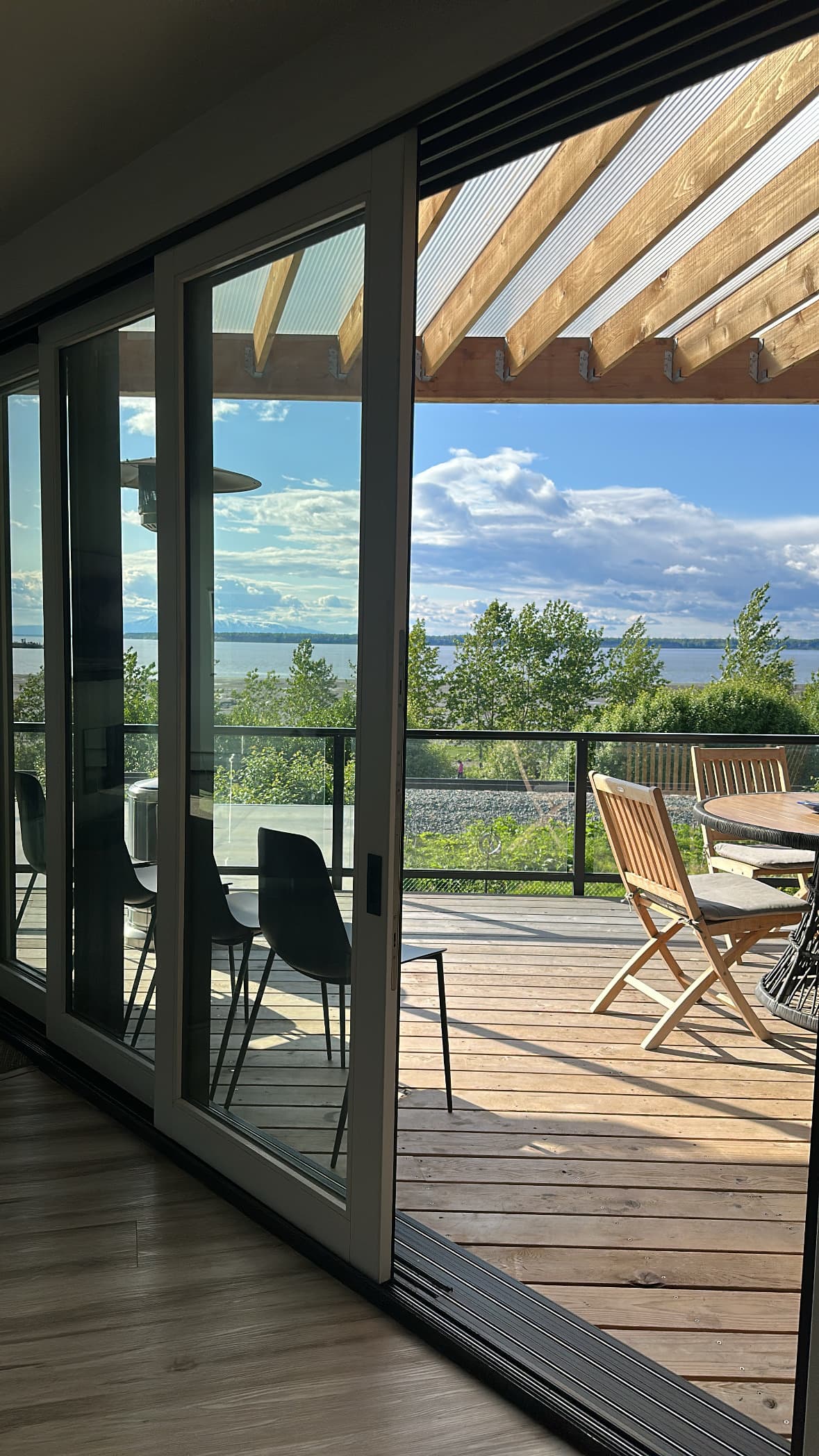 Interior view to outdoor deck and Cook Inlet panorama, Villa at Bootleggers Landing