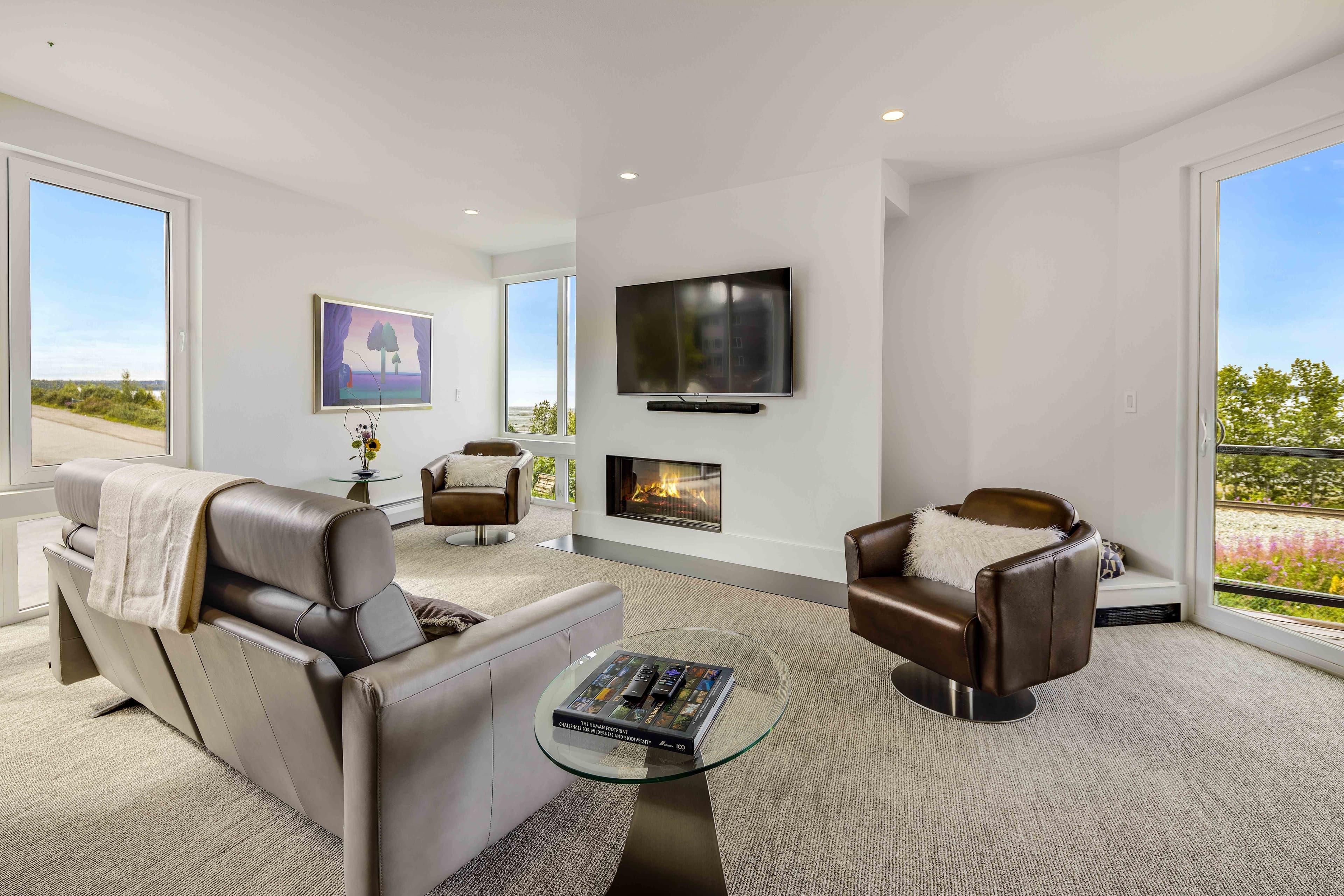 Spacious living room with fireplace and floor-to-ceiling windows, Villa at Bootleggers Landing