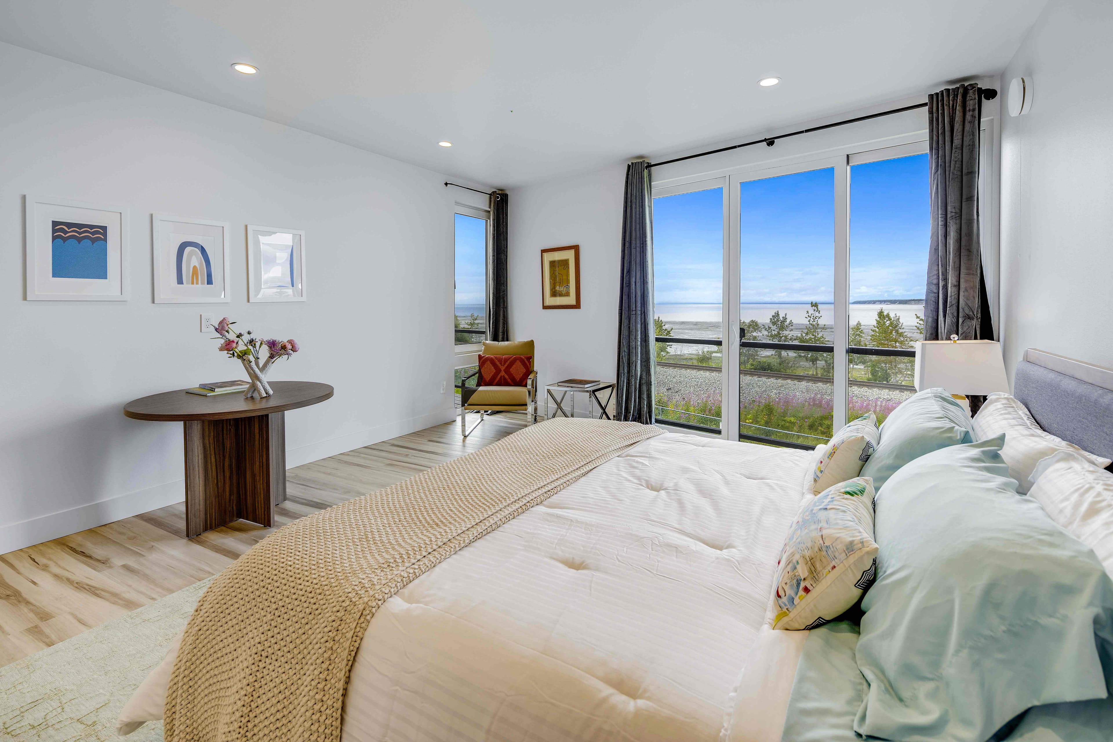 Master suite with panoramic Cook Inlet views and king bed, Alaska luxury accommodation