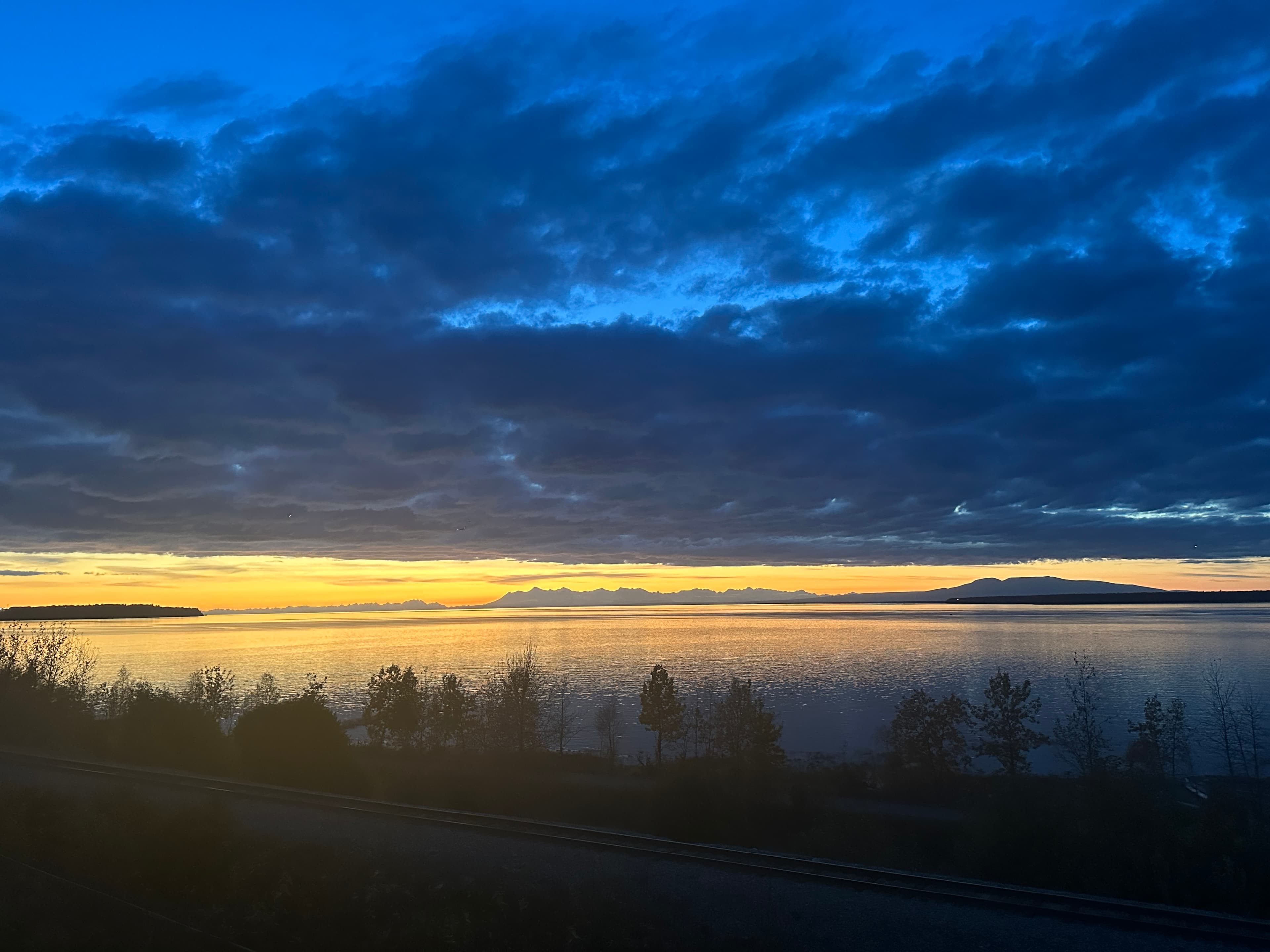 Midnight sun over Cook Inlet and the Alaska Range as seen from Villa at Bootleggers Landing