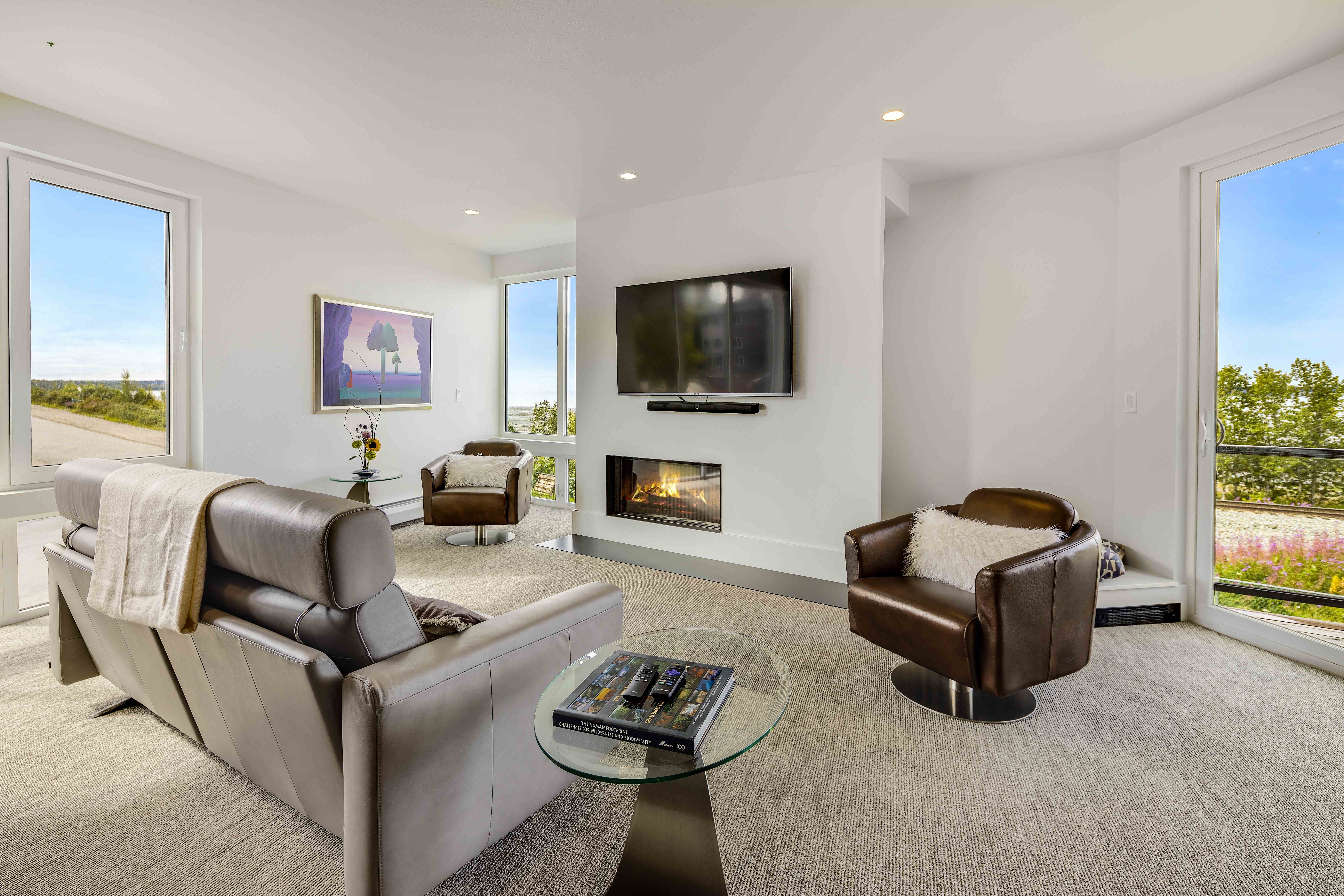 Spacious living room with fireplace and floor-to-ceiling windows, Villa at Bootleggers Landing